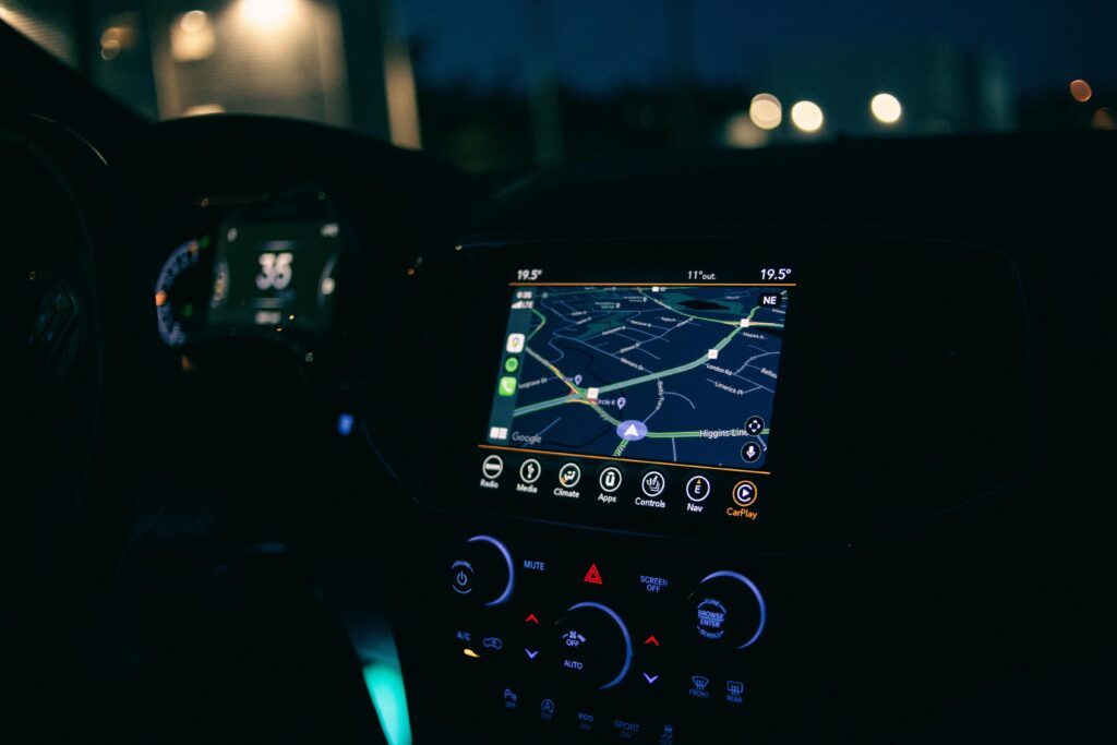 Interior view of a car featuring the GPS navigation system illuminated at night, showcasing technology and modern travel.
